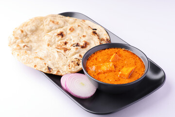 Paneer butter masala with roti and chopped onion Indian lunch
