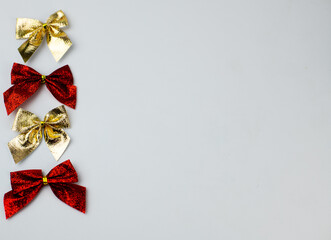 Red and gold christmas bows on white background