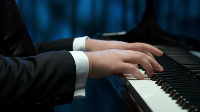 man pianist two hands plays energetic classical music on a beautiful grand