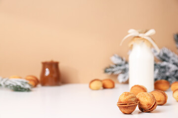 Nut cookies with a bottle of milk and a Christmas tree branch