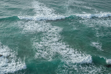 Fototapeta na wymiar Ocean foamy pattern on water surface. Top view.