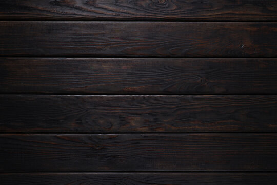 Dark brown wooden background, top view