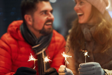 Photo of couple with New Year sparklers