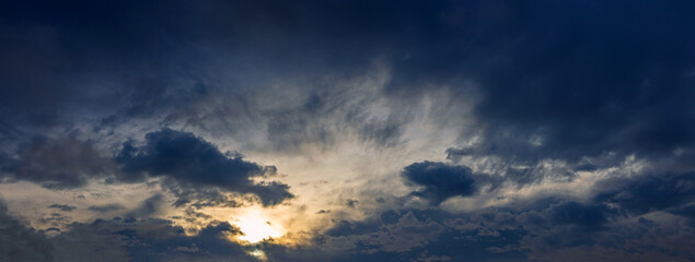 Dark ominous sky with blue clouds during sunrise