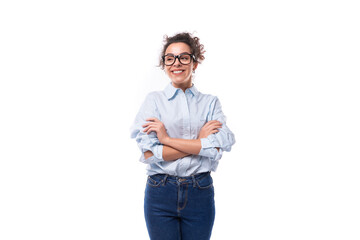 pretty slender young brunette curly employee of the company woman dressed in a light blue shirt and...