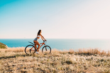 Sporty attractive woman with bicycle in outdoor. Lifestyle with young lady..