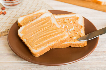 Peanut butter sandwiches or toasts on light table background.Breakfast. Vegetarian food. American cuisine top view vith copy space