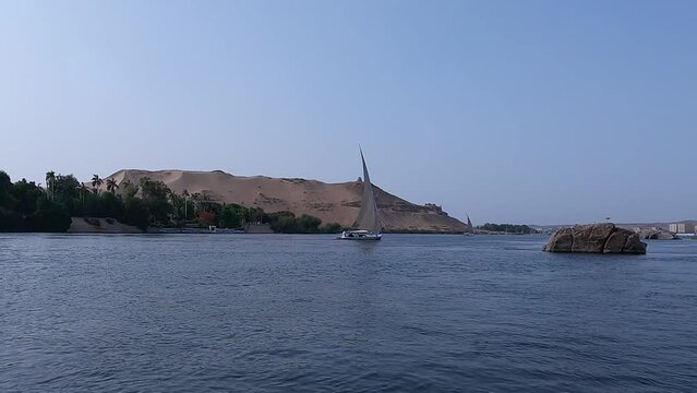 Traditional Felucca Boat Sailing On Nile River In Egypt. wide shot