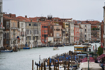 Grand Canal in center of Venezia. Panoramic view on old Italian houses and boats in historic center of the city. Venice - 5 May, 2019