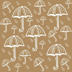 various umbrellas and blue rain drops on brown background