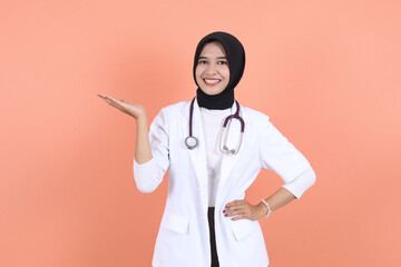 asian doctor muslim showing something aside copy space