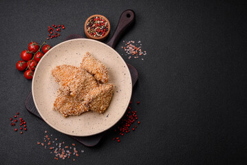 Delicious fresh crispy chicken nuggets on a dark concrete background