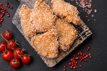 Delicious fresh crispy chicken nuggets on a dark concrete background