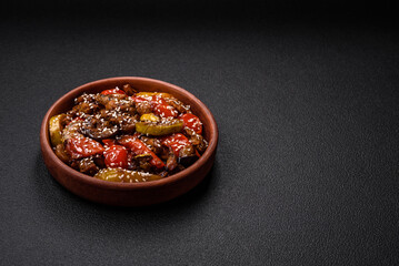 Warm salad with veal, tomatoes, peppers, zucchini, sesame, salt, spices and herbs