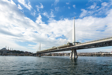 Long exposure. View of Haliç Metro Bridge connecting Azapkapı (Beyoğlu) and Unkapanı (Fatih) (Halic Metro Bridge). blue sky Istanbul Turkey	