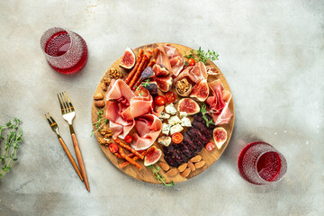 Italian appetizer prosciutto ham salami cheese appetizers with figs wine. Appetizers table with...
