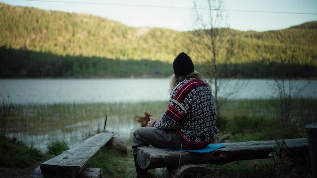 Hildremsvatnet, Trondelag County, Norway - A Man Enjoying a Hot Drink by the Lake - Static Shot
