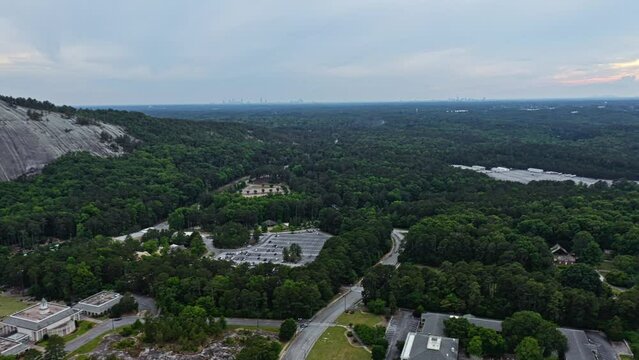 Aerial panorama view of Stone Mountain surrounded by forest during cloudy day 
