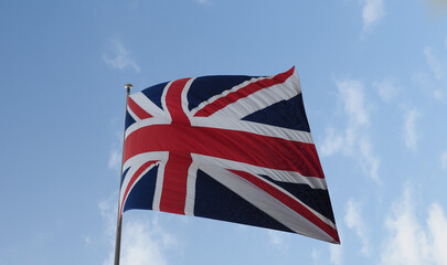 Union Jack flag of the United Kingdom over blue sky