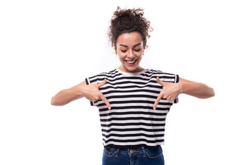 Fototapeta premium a young caucasian woman with a curly haircut is dressed in a striped summer t-shirt enthusiastically actively gesturing