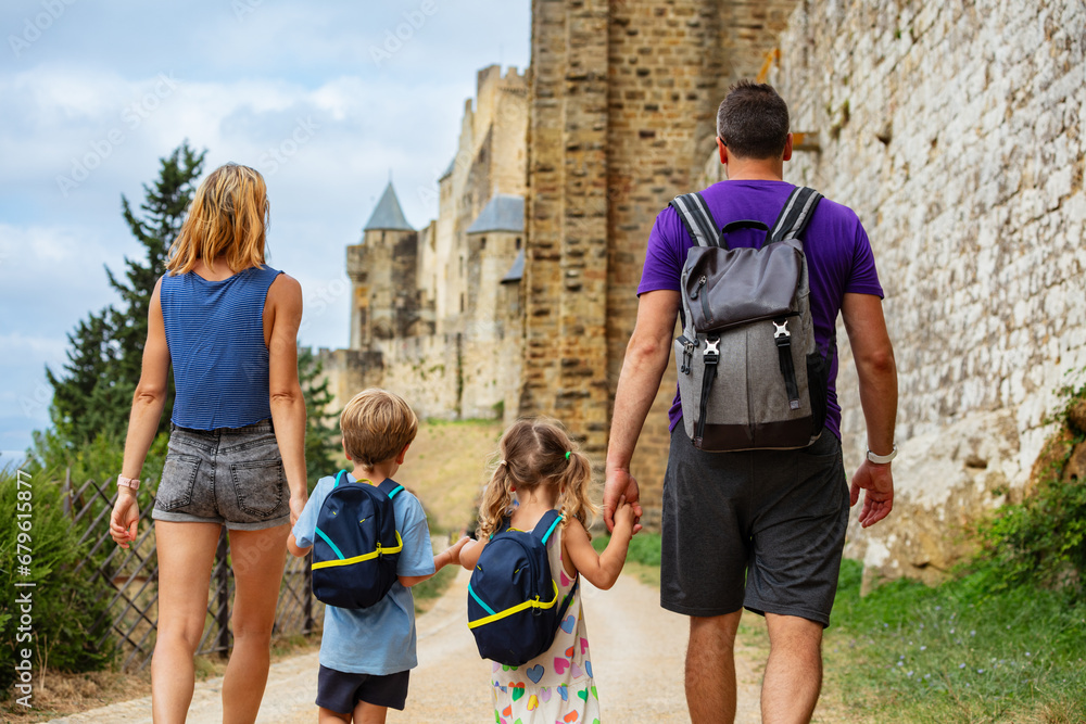 Wall mural family explores carcassonne, admires historic walls and towers