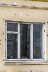 Fototapeta na wymiar Old wooden three-leaf window. Painted white.