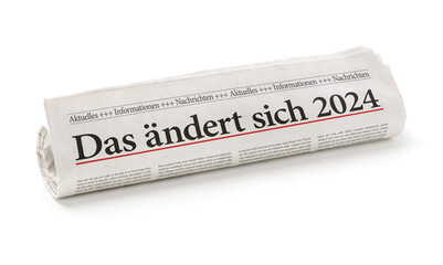 Zeitungsrolle mit der Überschrift Das ändert sich 2024 - obrazy, fototapety, plakaty