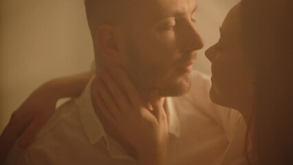 Close up affectionate young couple closed eyes embrace together comfort atmosphere. Sensual lady touching her man indoors. Caucasian married pair in love cuddling. Romance two people tender kisses