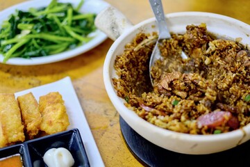 Claypot chicken rice, house specialty seafood bean curd with sweet chilli and mayo dipping sauce, stir-fried sweet potato leaves at Heun Kee Claypot Rice, a restaurant in Pudu, Kuala Lumpur, Malaysia