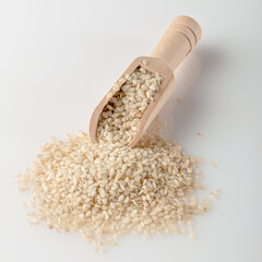 White sesame seeds lie on the table in a scoop..White sesame used for cooking. Cooking spice.