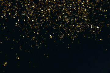 Abstract background of blurred yellow lights for design. Lights bokeh dis focus. Golden sequins on...
