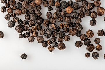 Peppercorns lie on the table..Peppercorns used for cooking. Cooking spice.