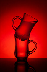 Glasses for tea on a red background..Glasses are on the table. Drink. Red background. Backlight.
