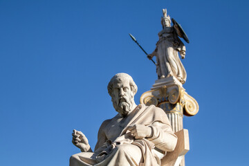 Marble statue of Greek philosopher Plato. Goddess Athena on background.