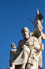 Marble statue of Greek philosopher Plato. Goddess Athena on background.