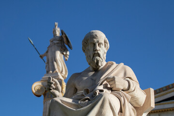 Fototapeta na wymiar Marble statue of Greek philosopher Plato. Goddess Athena on background.