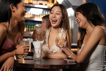 Beautiful Asian Woman Enjoying with Friend in Bar. They Enjoying with Night Party Together. Party, Lifestyle, Happiness, Cheerful and Celebration Concept. 