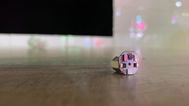 Blue and red light stop blinking from small electronic device circuit board on table surface