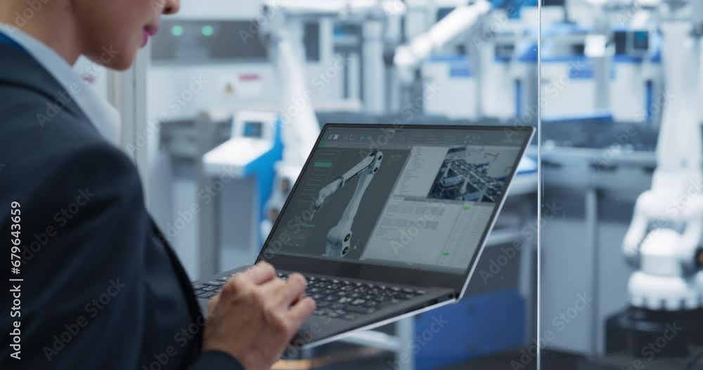 Poster Manufacturing Robot Arms Administrator Programming Robotic Vision Systems to Execute Production at an Electronics Factory. Over the Shoulder Footage of a Female Supervising Assembly with a Computer