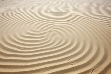 Fototapeta na wymiar sand patterns on a clean beach making gentle swirls