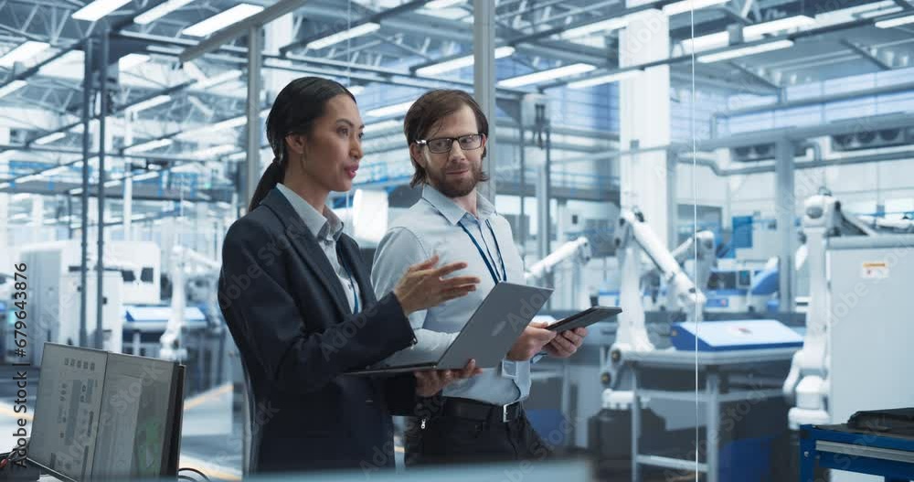 Aufkleber Male Engineer and Female Project Manager Standing in Office, Talking, Using Computers and Monitoring Production at a Modern Automated Electronics Manufacture with AI Robotic Arms