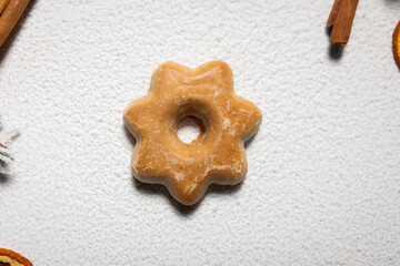 Star-shaped gingerbread on a white snowy background