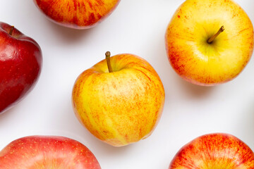 Variety of fresh apples on white background.
