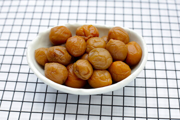Pickled plums on white background.