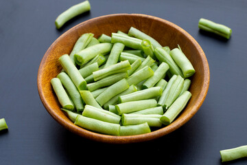 Green beans on dark background.