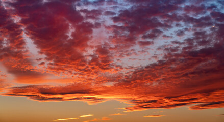 Red sunset cloudscape with dramatic blazing cumulus clouds