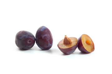 Two Whole and Halves purple plums isolated on white background. .