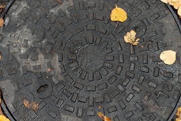 Inspection chamber or manhole of a sewerage system. Round cast iron inspection cover, Metal manhole...