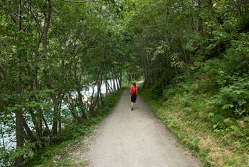 A woman hiking along a river in the mountains in western Norway.