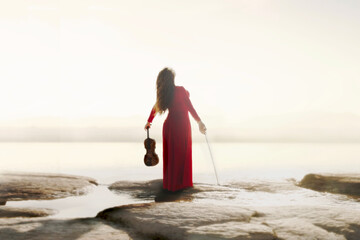 woman with violin in hand takes energy from the sun, abstract concept